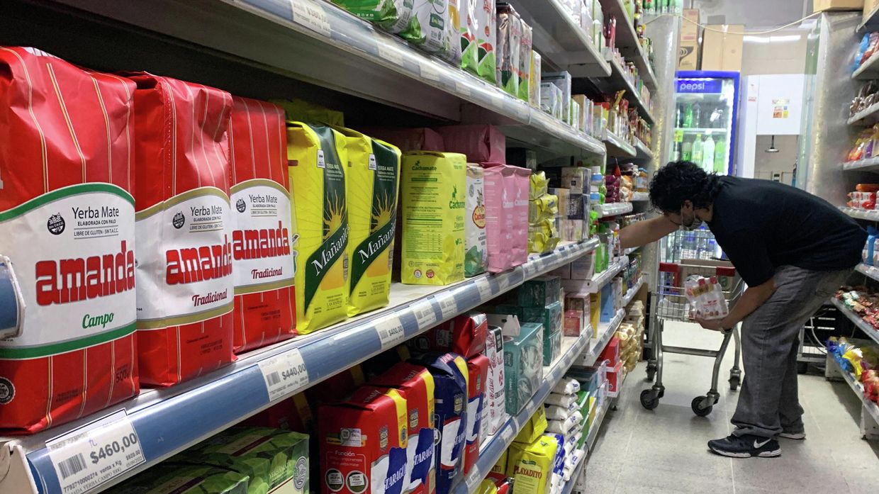 Мужчина раскладывает продукты в супермаркете в Буэнос-Айресе, 16 сентября 2022 года.