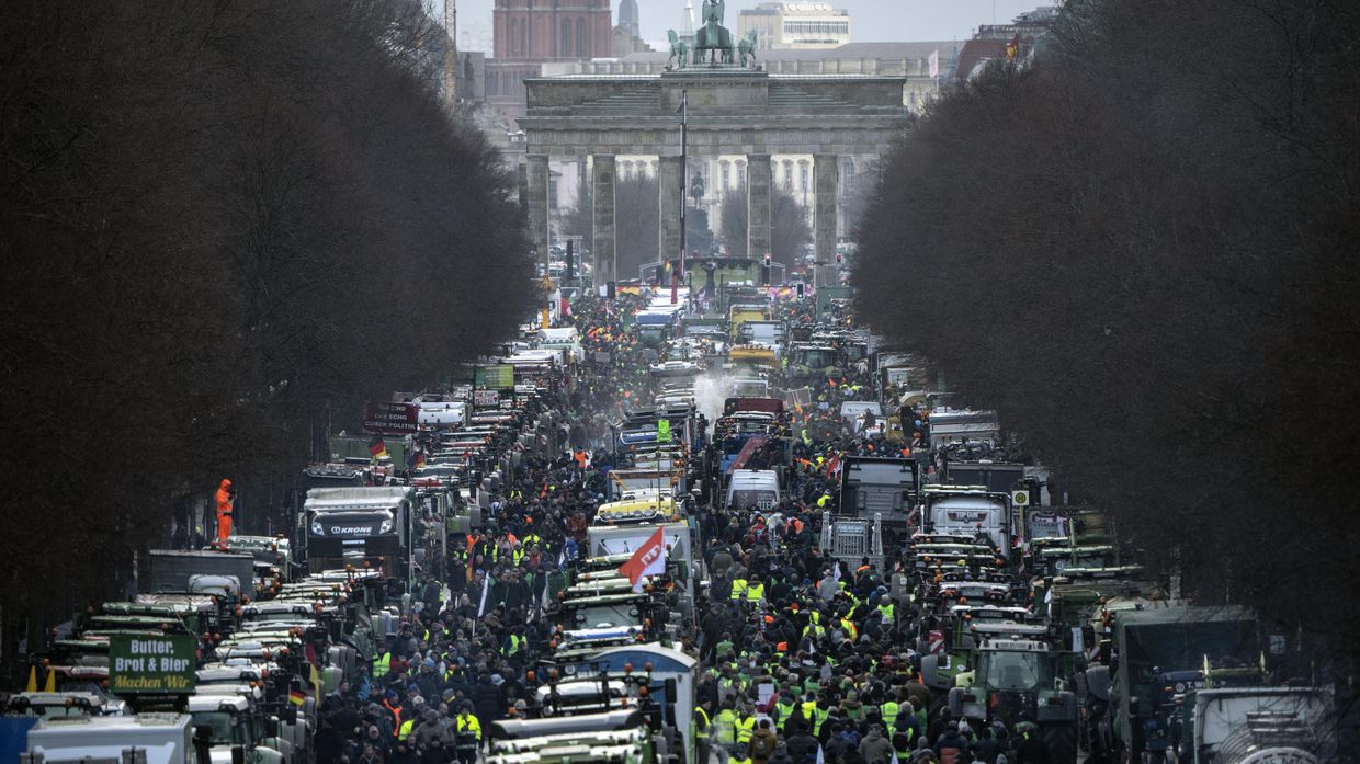 Фермеры с тракторами протестуют у Бранденбургских ворот в Берлине против плана отмены налоговых льгот на используемое ими дизельное топливо. 15 января 2024 года