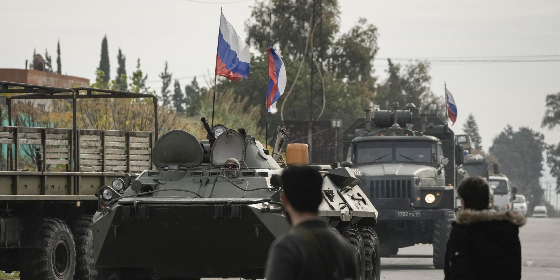 Сирийские боевики наблюдают за российской бронетехникой, проезжающей мимо авиабазы Хмеймим, которая в настоящее время находится под управлением России, в городе Хмеймим, Сирия, 16 декабря 2024 года. - ИноСМИ, 1920, 03.02.2025