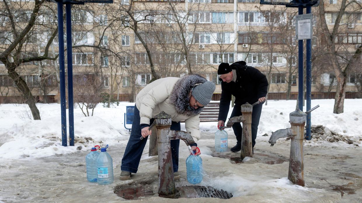 Люди набирают воду из общественной колонки в Киеве