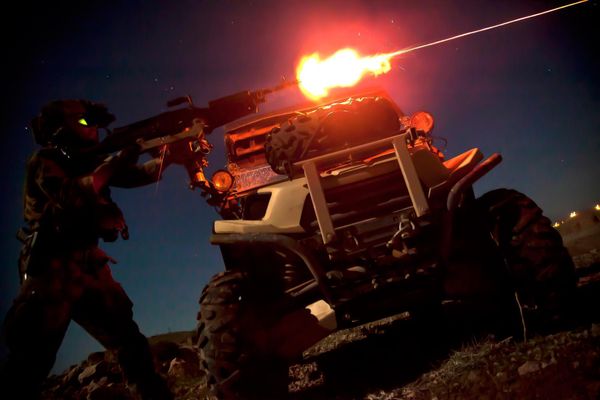 Морпех из команды спецопераций стреляет из пулемета M240B во время ночной тренировки в Афганистане