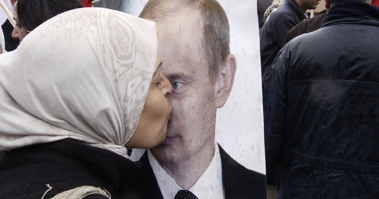 Сирийская женщина целует портрет президента РФ Владимира Путина