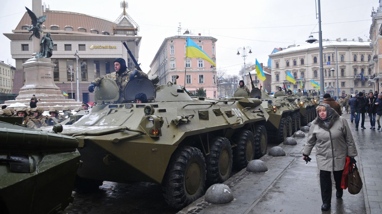Горожане у колонны бронетехники перед началом Марша защитников Украины, по случаю празднования 25-й годовщины Вооруженных сил Украины, во Львове