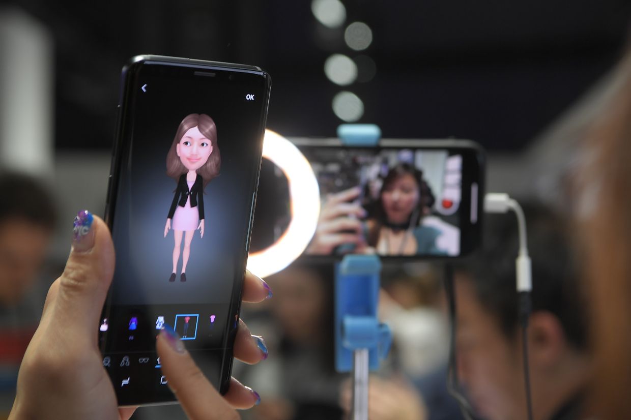 Женщина держит новый смартфон Samsung Galaxy S9 во время мероприятия Samsung Galaxy S9 Unpacked накануне MWC в Барселоне, Испания. 25 февраля 2018 года