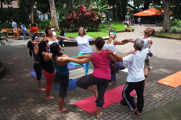 Люди занимаются йогой на площади Испании в Сан-Хосе, Коста-Рика