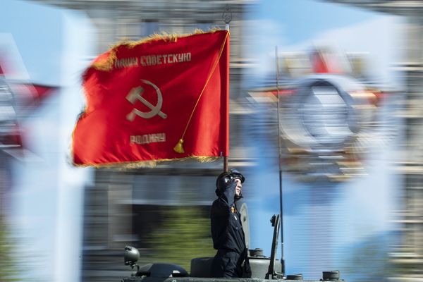 Солдат с флагом времен Великой Отечественной войны во время генеральной репетиции парада
