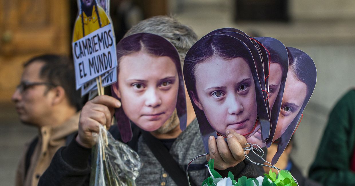 Маски Греты Тунберг во время акции протеста против изменения климата в Сантьяго, Чили Маски Греты Тунберг во время акции протеста против изменения климата в Сантьяго, Чили