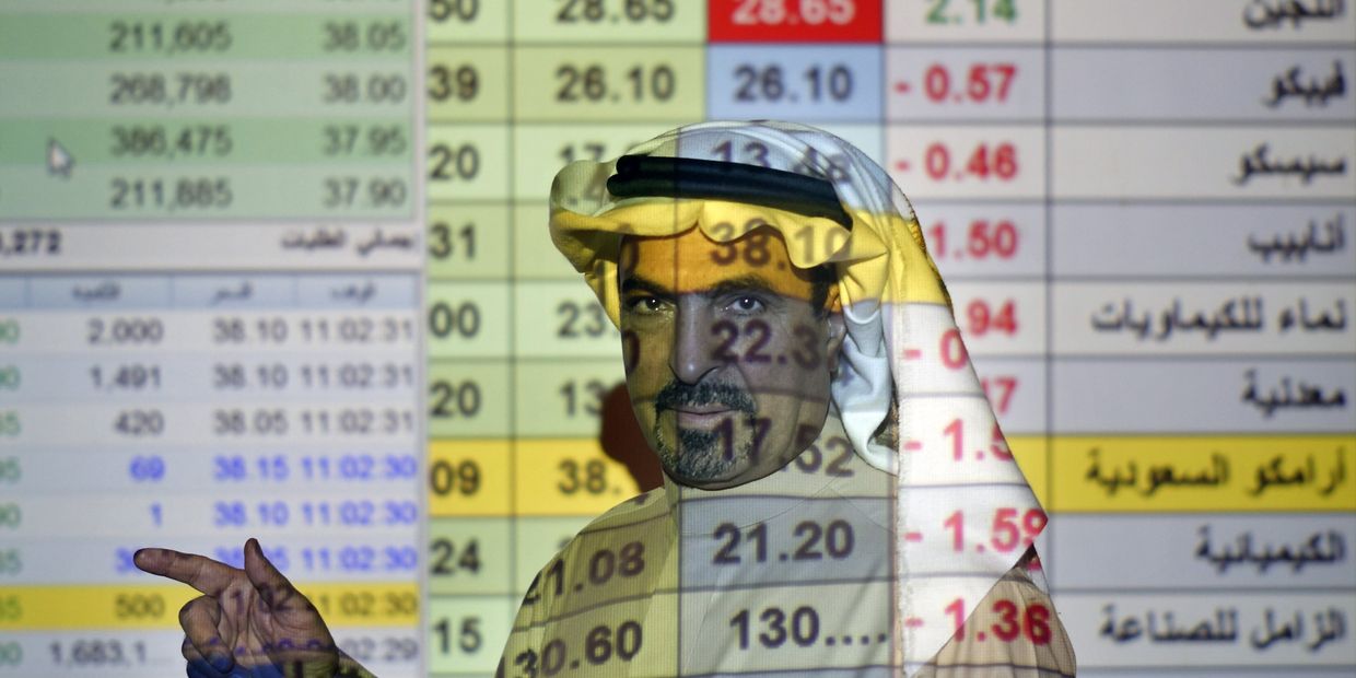 Трейдер говорит о ценах на нефть в банке в Эр-Рияде, Саудовская Аравия
