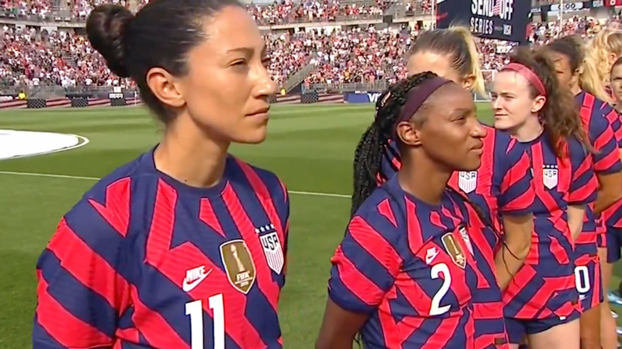 Members of the U.S. Women’s Soccer Team turned backs as 98-year-old World War II veteran Pete DuPré